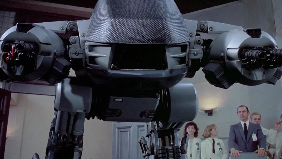 Still from RoboCop illustrating ED-209 Misfires